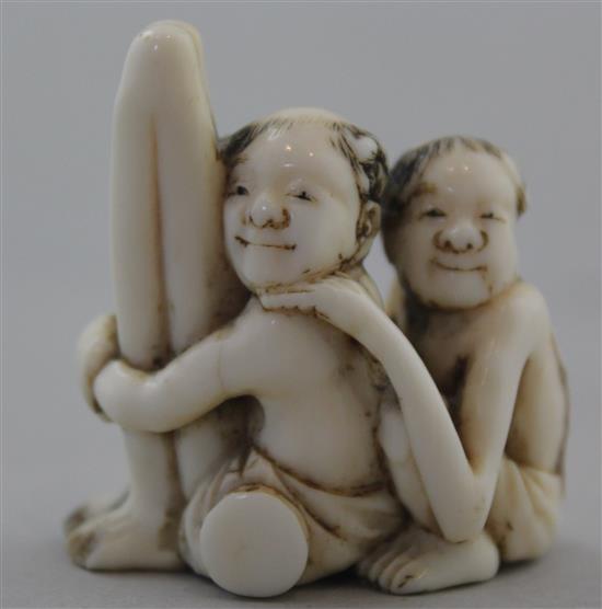 A Japanese ivory netsuke of seated Ashinaga and Tenaga, Meiji period, 3.7cm, repair to one foot